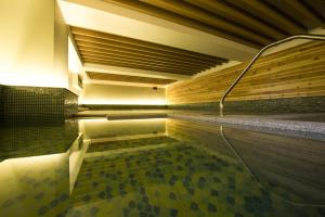 a swimming pool in a building with a ceiling at Just Sleep Jiao Xi in Jiaoxi