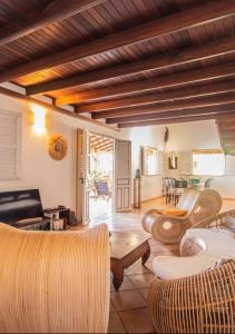 a living room with a couch and chairs and a table at Papeth House in Le François