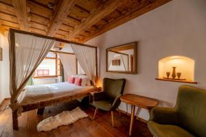 a bedroom with a bed and a chair and a mirror at Boutique Hotel von Graf in Sighişoara