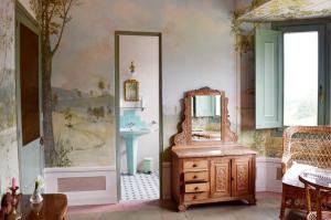 a bathroom with a mirror and a wooden dresser at PACA casa rural. Arts and Landscape in Asturias in Gijón