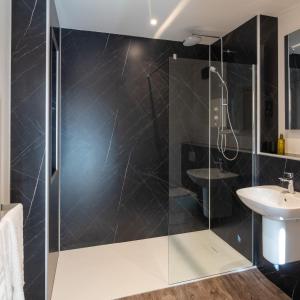 a bathroom with a shower and a sink at The Birdbox - Unique Cabin in Millport in Millport