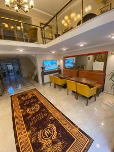 a dining room with a table and chairs and a rug at Hotel Mavirem in Istanbul