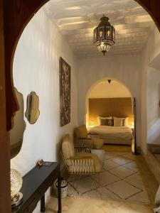 a bedroom with a bed and a chandelier at Riad Djebel in Marrakech