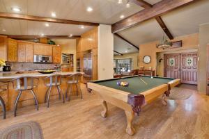 a pool table in a room with a kitchen at 2012-Moose Manor home in Big Bear Lake