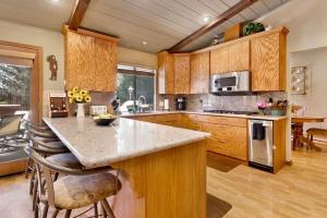 a large kitchen with wooden cabinets and a counter top at 2012-Moose Manor home in Big Bear Lake