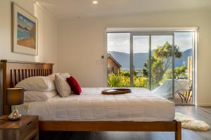a bedroom with a bed with a view of the mountains at River View Collingwood in Collingwood
