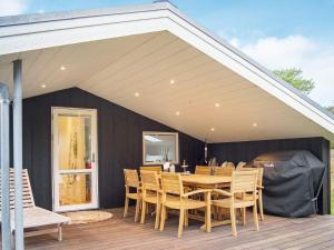 a patio with a table and chairs on a deck at Holiday home Thisted LIII in Thisted