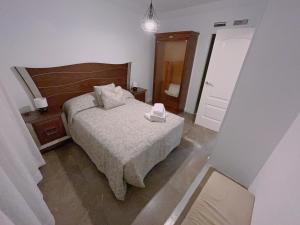 Un pat sau paturi într-o cameră la Piso Atares Calle Alfonso