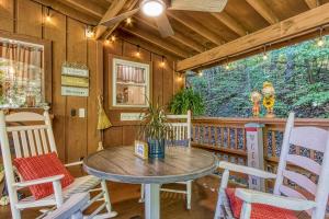 a dining room with a table and chairs at Cozy Cabin with Mountain Views Near SkyLift Park! in Gatlinburg