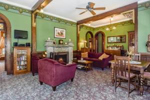 a living room with green walls and a fireplace at The KirkHouse Bed and Breakfast in Friday Harbor