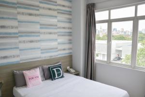 Ένα ή περισσότερα κρεβάτια σε δωμάτιο στο DUTA HOTEL