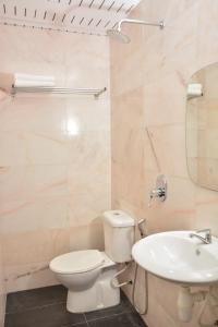a bathroom with a toilet and a sink at DUTA HOTEL in Kuala Lumpur
