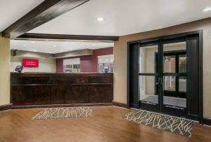 a waiting room with a cash register and a door at Red Roof Inn & Suites Knoxville East in Knoxville