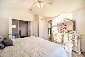 a bedroom with a white bed and a large mirror at Littleton Home with Patio - 8 Mi to Red Rocks in Littleton
