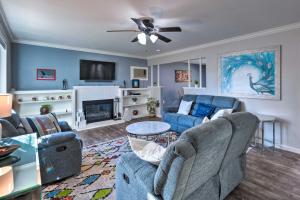 a living room with two couches and a tv at Vibrant Sacramento Home with Yard and Patio! in Freeport
