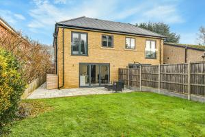 a brick house with a fence and a yard at Valley house in Biggin Hill