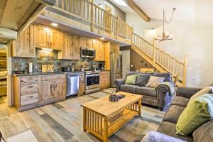 een grote woonkamer met een bank en een tafel bij Walk to Grand Lake Riverfront Gem with Fireplace! in Grand Lake