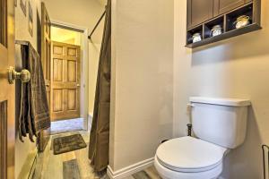 een badkamer met een toilet en een deur bij Walk to Grand Lake Riverfront Gem with Fireplace! in Grand Lake +23 foto's