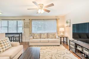 a living room with a couch and a ceiling fan at Bright Hinesville Home, 43 Mi to Savannah! in Hinesville