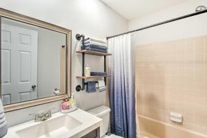 a bathroom with a sink and a toilet and a mirror at Bright Hinesville Home, 43 Mi to Savannah! in Hinesville +20 photos