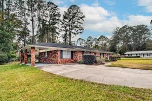 a brick house with a driveway at Bright Hinesville Home, 43 Mi to Savannah! in Hinesville