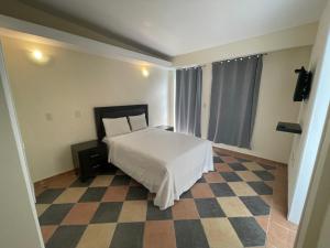 A bed or beds in a room at Hotel Real Home