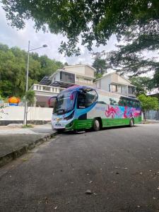 a bus parked on the side of a street at 15PAX 3 BR, Kids Swimming Pool, Pool table, BBQ near Spice ARENA, Airport Penang in Bayan Lepas