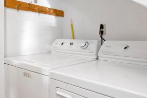 uma lavandaria com duas lavadoras brancas em 2195-Slopeside Views Chalet home em Big Bear Lake