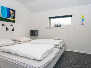 two beds in a white room with a window at 8 person holiday home in Tarm-By Traum in Fjerbæk
