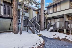 a house with stairs and trees in the snow at 2125-Switzerland Slopes townhouse in Big Bear Lake