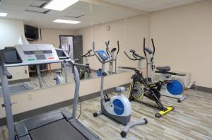 a gym with bikes and exercise equipment in front of a mirror at Days Inn by Wyndham Harriman in Harriman