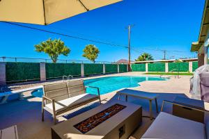 a patio with a pool and a couch and a table at Luxury Old Town Scottsdale Home with Pool King Bed & Putting Green - Casa Gram in Scottsdale