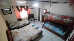 Habitación pequeña con 2 literas y ventana en BAMBU HOSTEL, en David