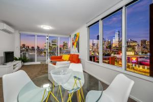 a living room with a view of a city skyline at Exclusive Stays - Rivergarden in Melbourne