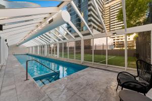a swimming pool in the middle of a building at Exclusive Stays - Rivergarden in Melbourne