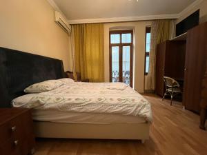 a bedroom with a bed and a large window at Chambers of the Boheme in Istanbul