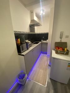 ロンドンにあるCosy 1 Bedroom Apartmentの紫色のライトが付くキッチン