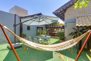 a hammock on the patio of a house at Nova Pousada dos Chás in Florianópolis