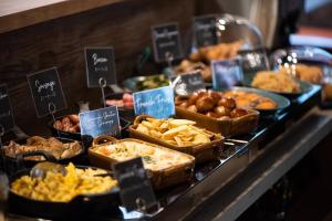 a buffet filled with different types of food on display at DEL style Ikebukuro Higashiguchi by Daiwa Roynet Hotel in Tokyo