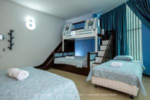 a bedroom with two beds and a bunk bed at Knight Alley Hotel in Taiping