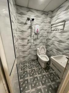 a bathroom with a shower and a toilet and a sink at Hotel Sri Maju Jaya in Kota Bharu