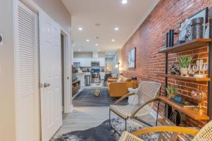 an open living room with a brick wall at Baltimore's Home Away From Home apts in Baltimore