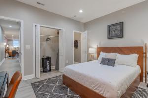 a bedroom with a large bed and a hallway at Baltimore's Home Away From Home apts in Baltimore