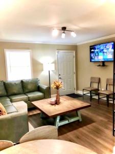 a living room with a couch and a table at Trinity One Apartments - Country Luxury in Jackson