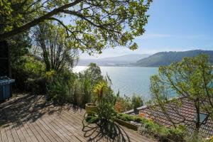 a wooden deck with a view of a body of water at Stairway to heaven in Dunedin