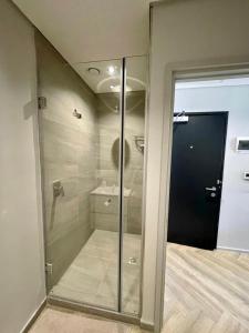 a walkin shower with a glass door in a bathroom at 1728 at One Thibault in Cape Town