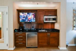 a kitchen with a sink and a microwave at MGM Signature Towers, Balcony Suite, Strip View - NO RESORT FEES! in Las Vegas