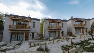 a large house with a courtyard in front of it at Dolkhar Resort in Leh