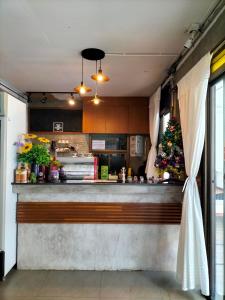 a kitchen with a christmas tree behind a counter at Baan Chiang Maan in Chiang Mai