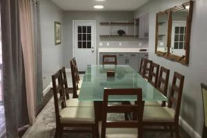 a dining room with a table and chairs and a kitchen at Luxury Estate 13bedrooms with Pool, Hot tub, Sauna, Bar in Memphis